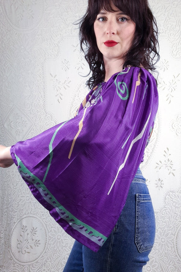 Model Holly shows off our purple abstract floral Scorpio top with big floaty sleeves.