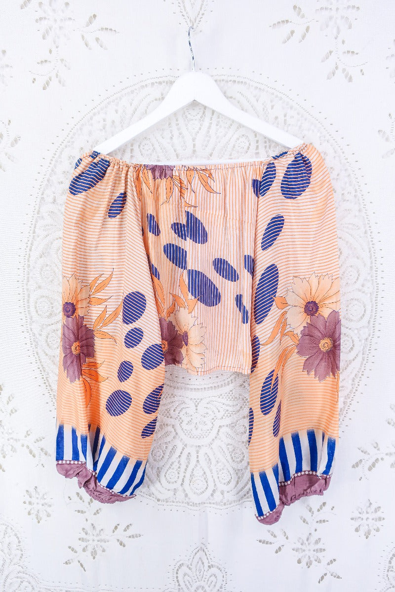 Our Ariel top in Apricot Bubble Stripe. Photo displays back design and flowy balloon sleeves. 