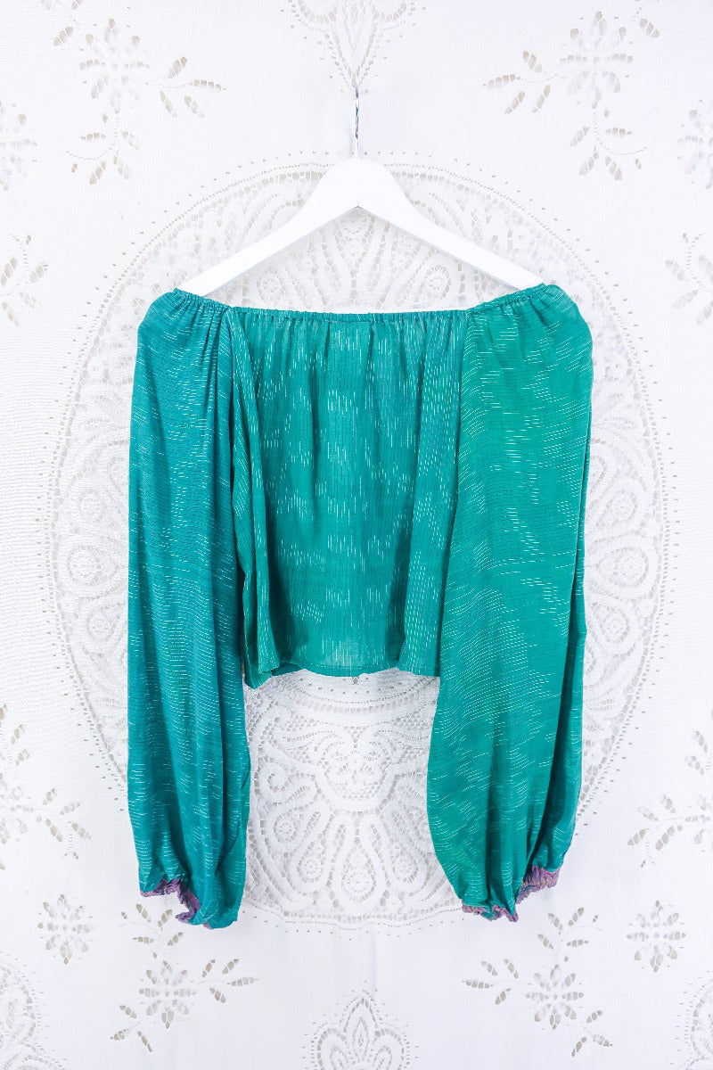 Back view of our Ariel top in emerald, micro pinstripe! this beautiful top is super flowy for those hot super days and versatile, great for layering. See photo for mauve and gold cuff detailing. 