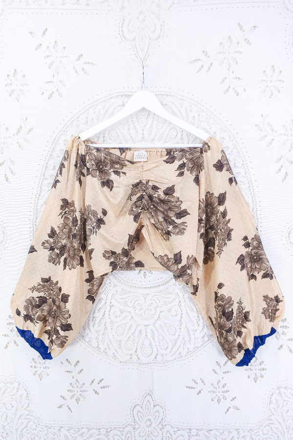 This Ariel top is a gorgeous sandy tone with muted brown florals and blue accents on the cuffs. A real beauty for a summery warm day, as well as a great layering piece. 