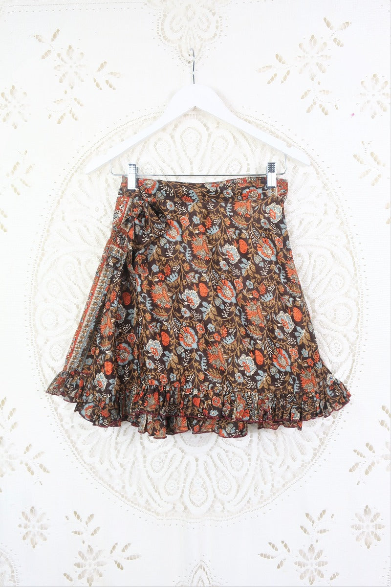 Front view of our Venus Mini wrap skirt. This skirt has a tie waist and is free size. Gorgeous baroque floral print in blue , orange and brown tones.