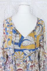 Photo shows close up of mannequin wearing our Daisy cotton smock top in a boho peacock block print design with balloon sleeves and a tie neckline.
