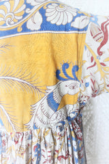 Photo shows a back close up of the mannequin wearing our Daisy cotton smock top in a boho peacock block print design with balloon sleeves and a tie neckline.