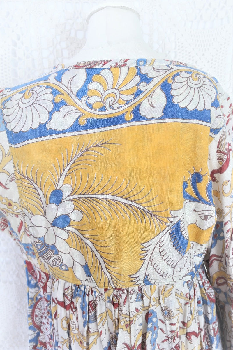 Photo shows back close up mannequin wearing our Daisy cotton smock top in a boho peacock block print design with balloon sleeves and a tie neckline.