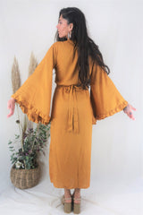 Back full photo of our Model wearing the Venus maxi. On the back is the adjustable tie waist which creates an elegant retro shape. A graceful maxi ankle length and oversized butterfly sleeves all in a soft vibrant yellow rayon fabric by All About Audrey