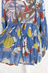 Photo shows a deep blue peacock and hand gesture block printed boho smock top with a tie neck and balloon sleeves.