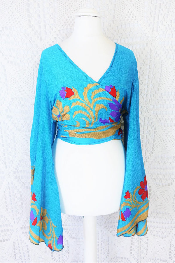 cerulean blue boho gemini bell sleeve wrap top with beige ruby red and purple bold floral print photographed on a UK size 8 mannequin by all about audrey