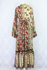 back of sylvia boho wrap dress in champagne with a red and black paisley and floral print. Waist ties have been tied into a bow and sit at the centre of the lower back