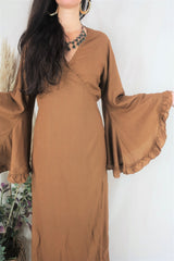 Close up of model showing off the ruffle bell sleeves and the earthy light brown colour. By All About Audrey