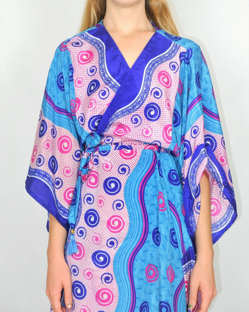 Close up photo of model wearing our Aquaria Kimono, shows the bright blue colourway and polka dot wave graphic print in more detail.