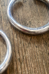 close up laid flat large silver painted hoop earrings from our boho jewellery collection at all about audrey