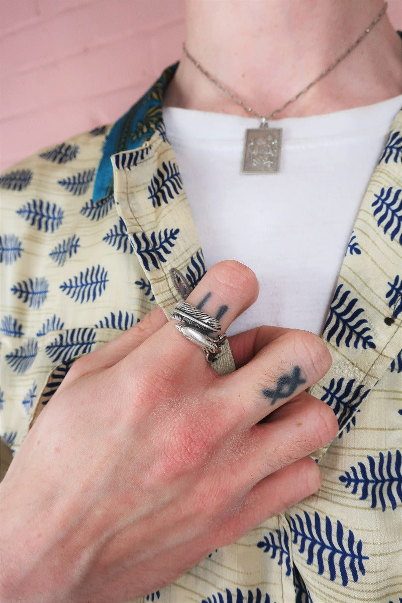 close up model wears silver plated eagle and feather ring with oxidised finish by all about audrey