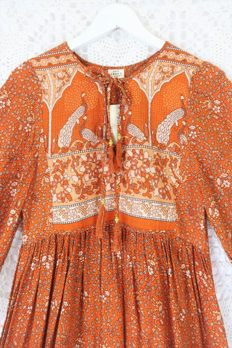 detail contrast printed yolk and tassel tie neckline peacock primrose bohemian midi dress with exaggerated balloon sleeve in burnt orange sustainable rayon by all about audrey