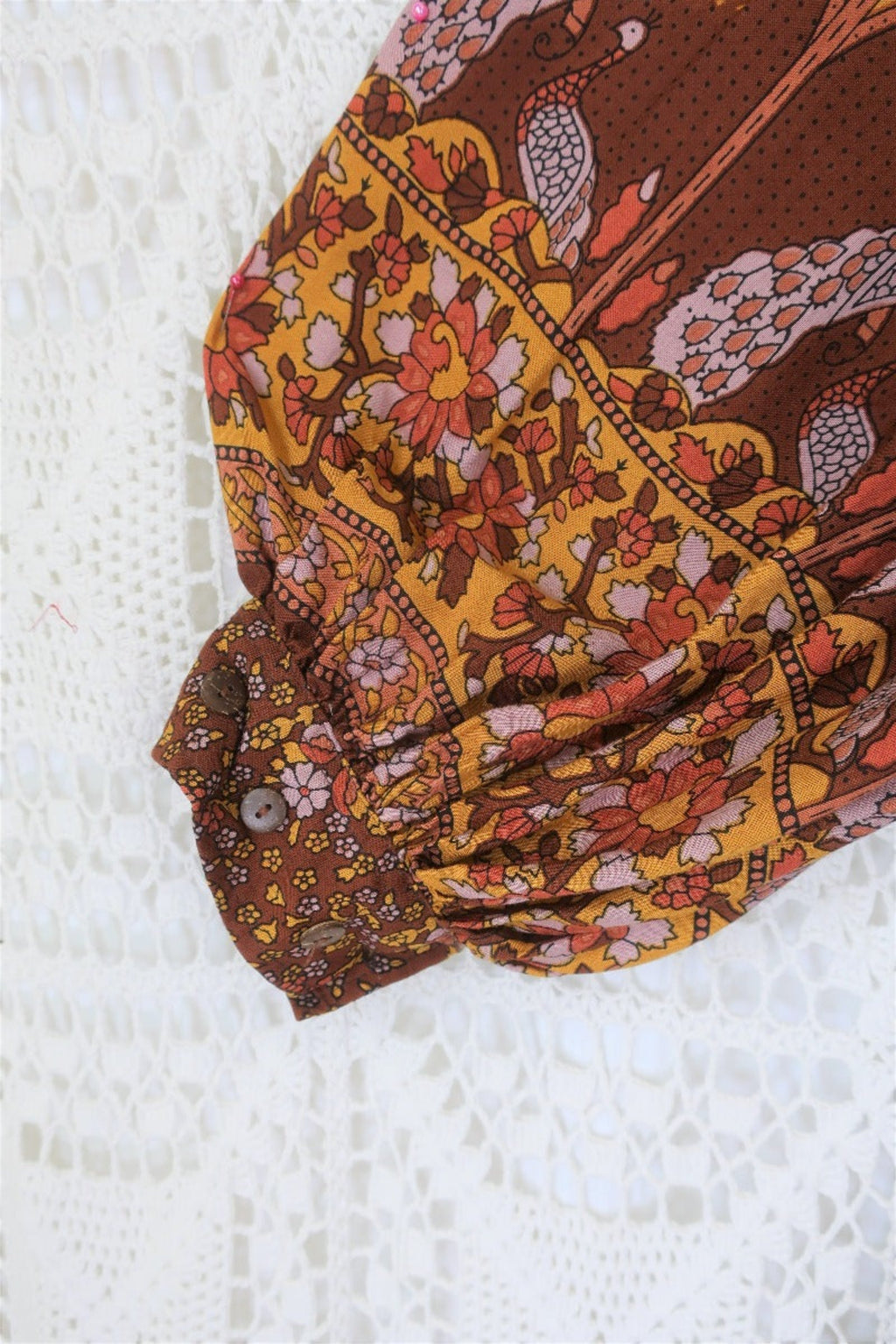 close up sleeve peacock primrose midi dress with balloon sleeves in 70s smocked style indian printed rayon colour gingerbread by all about audrey