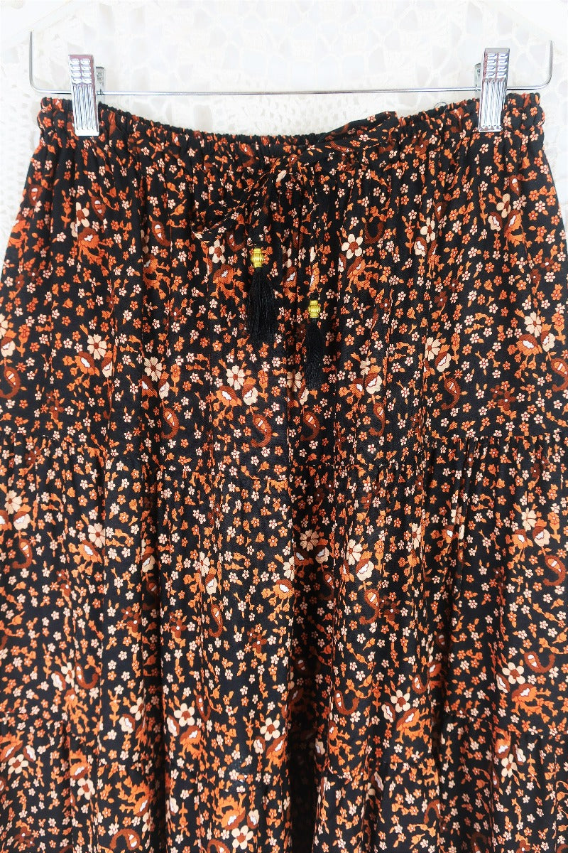 close up elasticated free size waist peacock prairie maxi skirt in indian block printed style sustainable rayon fabric colour jet black and terracotta by all about audrey