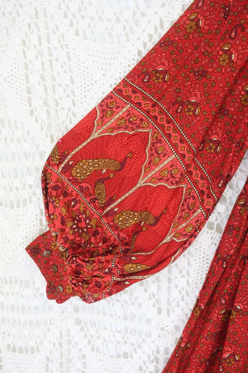 detail of contrast printed balloon sleeve on smocked style peacock primrose midi dress in berry red with gold detailed vintage inspired indian peacock design from our collection of bohemian dresses by all about audrey