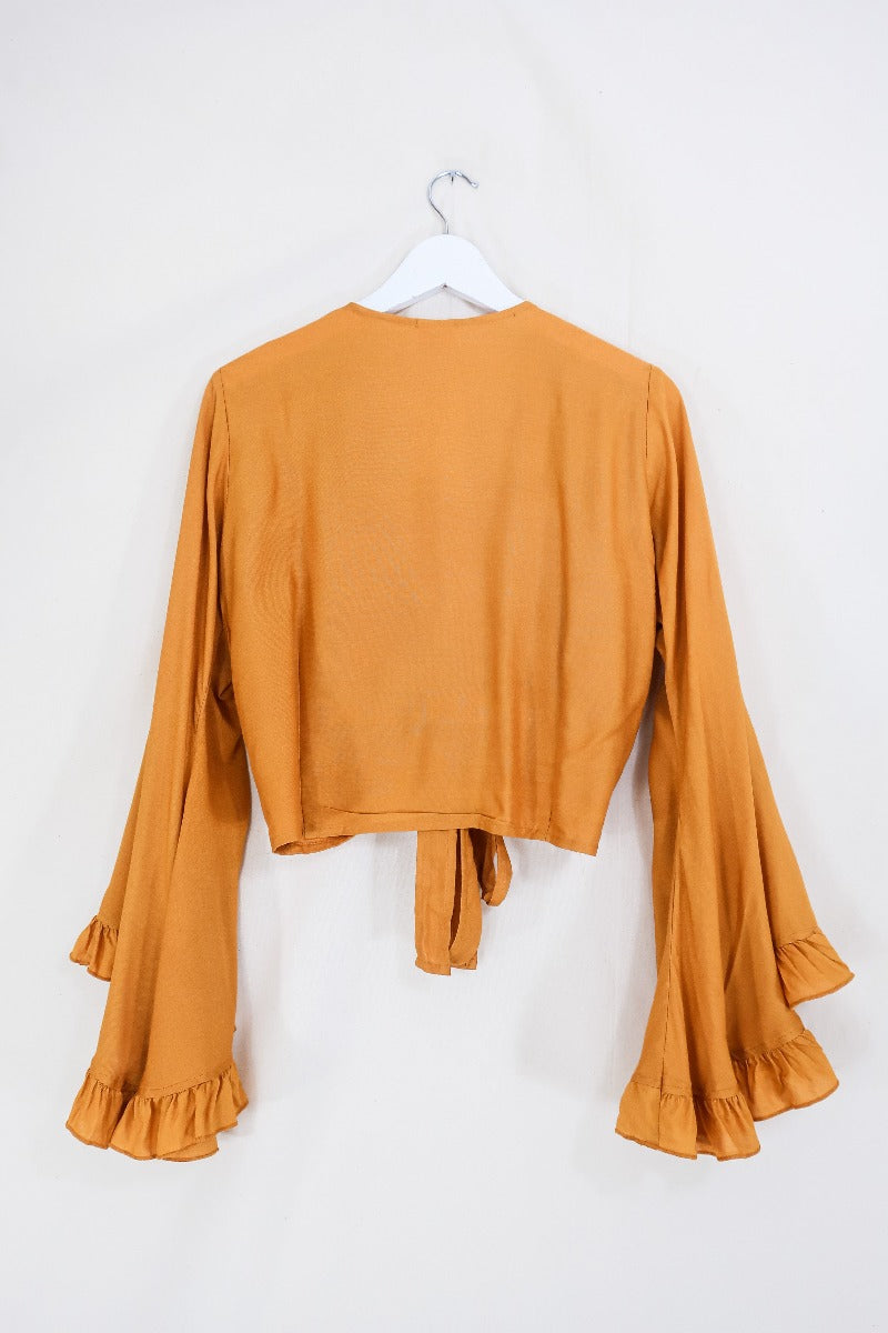 Flatlay of our Khroma Venus top in Mustard Yellow by All About Audrey