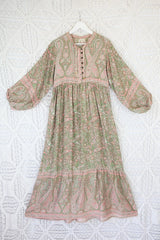 photograph of florence maxi dress in sage and blush paisley design laid flat to show balloon sleeve shape and skirt length with contrast printed button down yolk by all about audrey