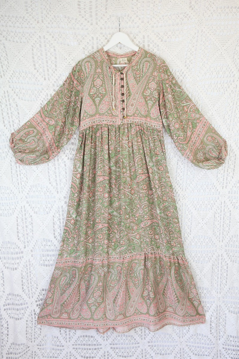 photograph of florence maxi dress in sage and blush paisley design laid flat to show balloon sleeve shape and skirt length with contrast printed button down yolk by all about audrey