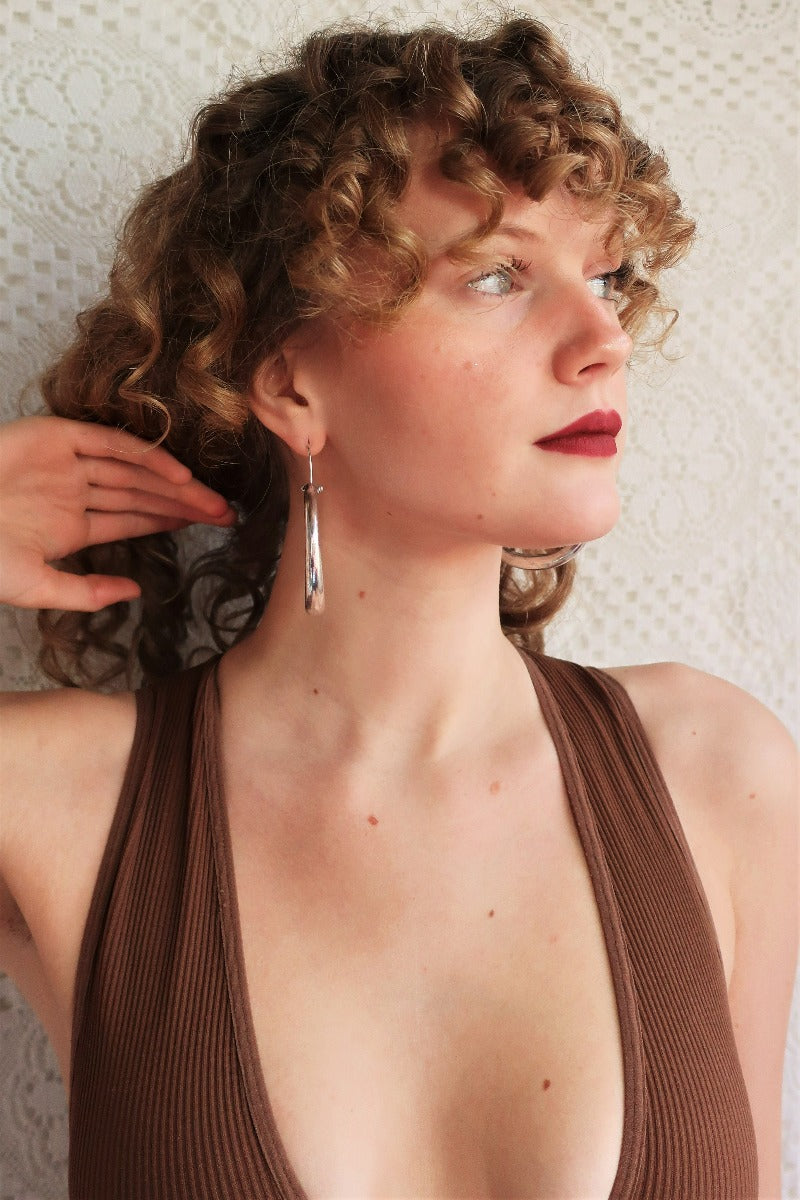 front view model wears large silver painted hoop earrings from our boho jewellery collection at all about audrey