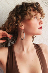 model wears large silver painted hoop earrings from our boho jewellery collection at all about audrey