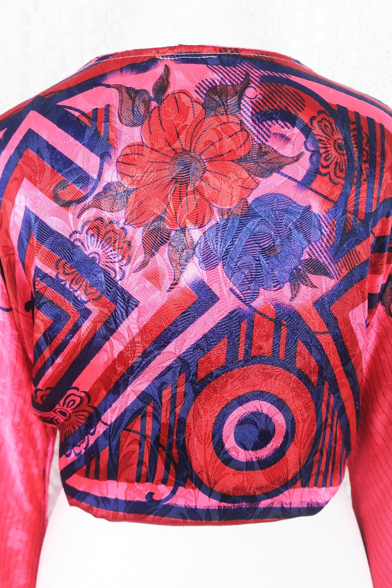 dark pink navy blue and red floral print gemini bell sleeve boho wrap top with shimmering jacquard stiching photographed on a uk size 8 mannequin by all about audrey