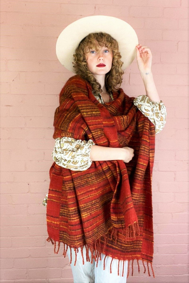 reversible stripy recycled Indian shawl in burnt red, black & mustard, worn draped over model's shoulders - All About Audrey