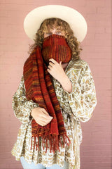 burnt red, black & mustard stripy recycled Indian shawl worn as a face covering by a model - All About Audrey