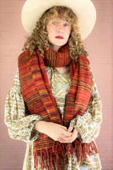 reversible recycled Indian scarf in burnt red with mustard & black stripes, worn wrapped twice around model's neck - All About Audrey