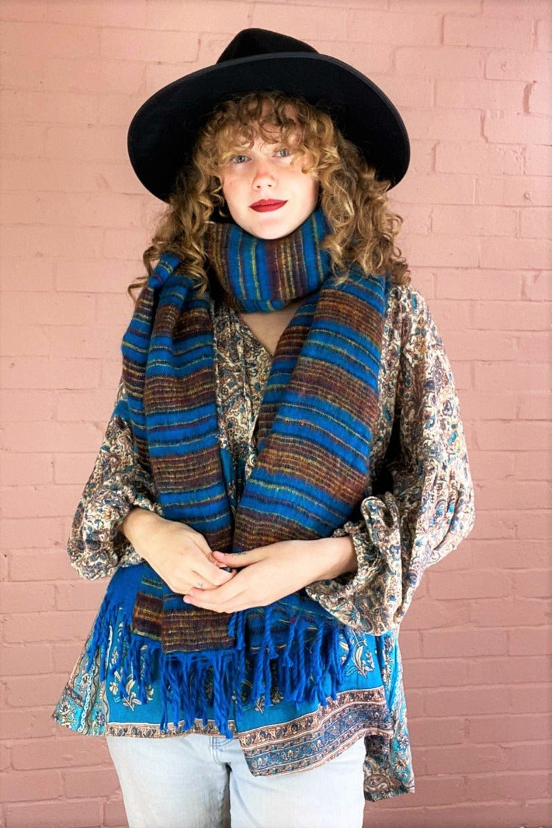 sapphire blue recycled indian scarf with red and gold stripes wrapped warmly around model's neck - All About Audrey