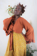 Model wears our Venus Khroma bell sleeve top in Red clay, a beautiful earthy orange tone inspired by bohemian 70s styles by all about audrey