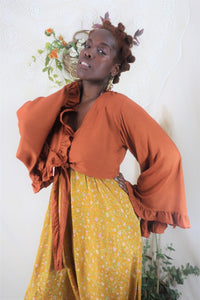 Model wears our Venus Khroma bell sleeve top in Red clay, a beautiful earthy orange tone inspired by bohemian 70s styles by all about audrey