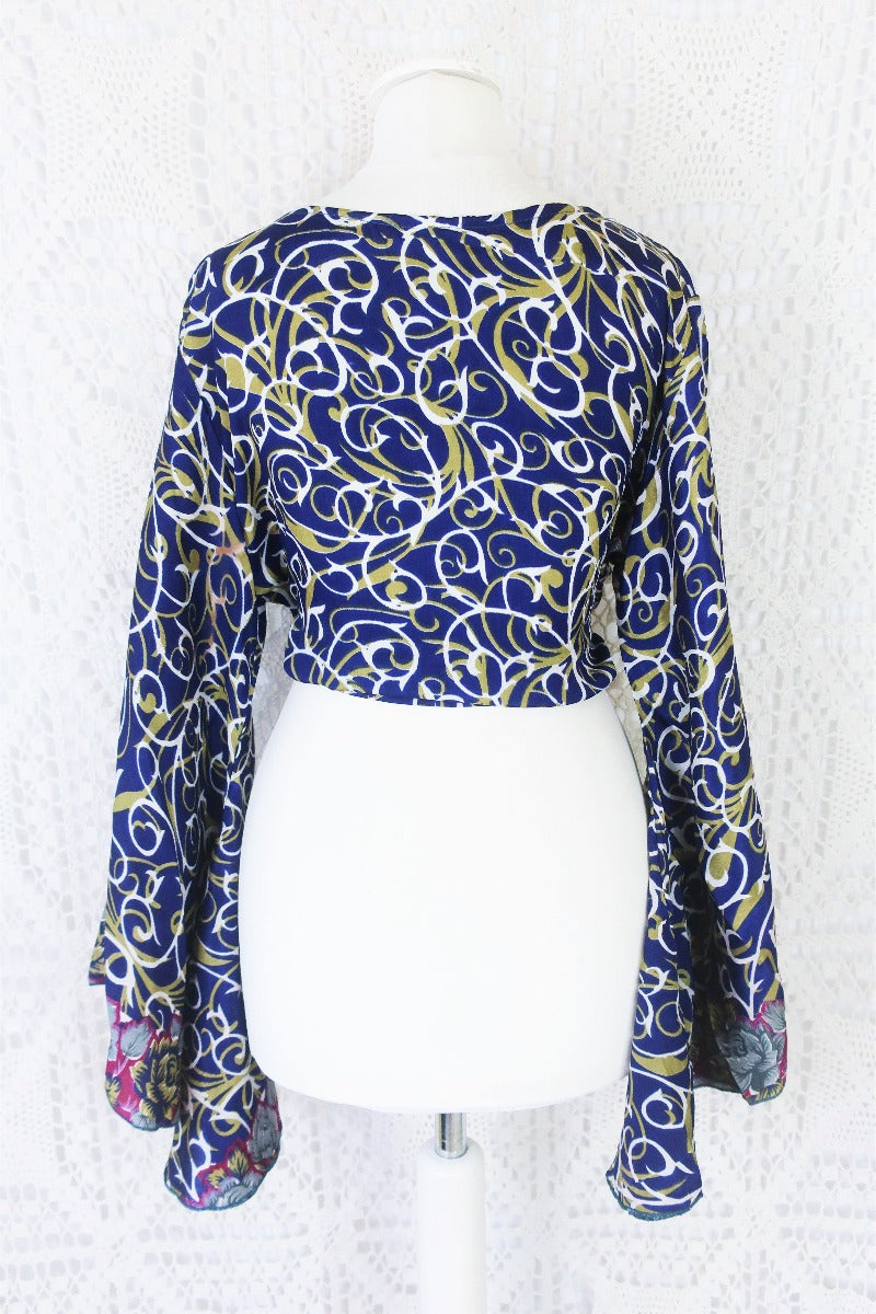 navy blue white and olive green block print with magenta and grey floral borders gemini boho bell sleeve wrap top photographed on a uk size 8 mannequin by all about audrey