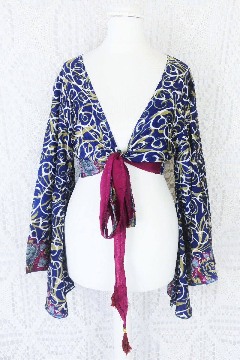 navy blue white and olive green block print with magenta and grey floral borders gemini boho bell sleeve wrap top photographed on a uk size 8 mannequin by all about audrey