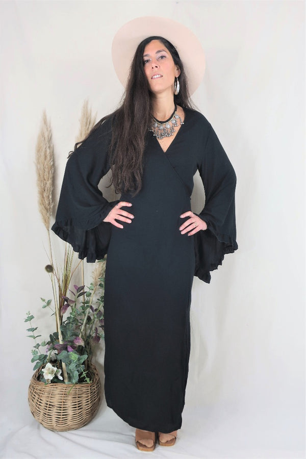 Model wears our Venus ruffle bell sleeve maxi in Nighshade Black. A beautiful vampy darkest black tone and elegant hourglass shape by All About Audrey