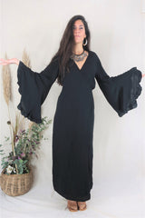 Full length photo of our model showing the retro butterfly style bell sleeves. A gorgeous soft rayon fabric is lightweight and sits well on the body. By All About Audrey