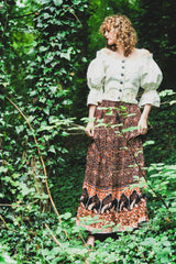 model wears peacock prairie maxi skirt in indian block printed style sustainable rayon fabric colour jet black and terracotta by all about audrey