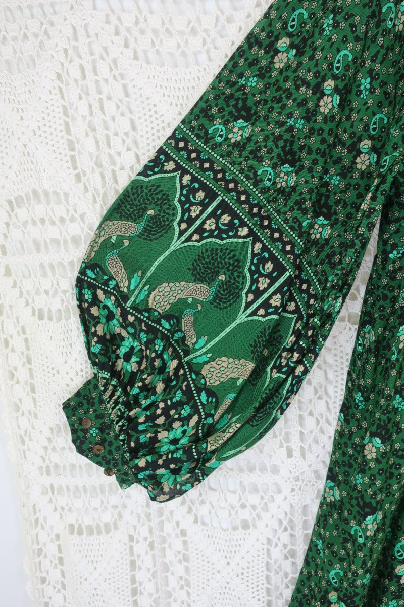detail of contrast design sleeve on indian peacock printed primrose midi length dress in forest green with exaggerated balloon sleeve in 1970s vintage inspired bohemian style by all about audrey