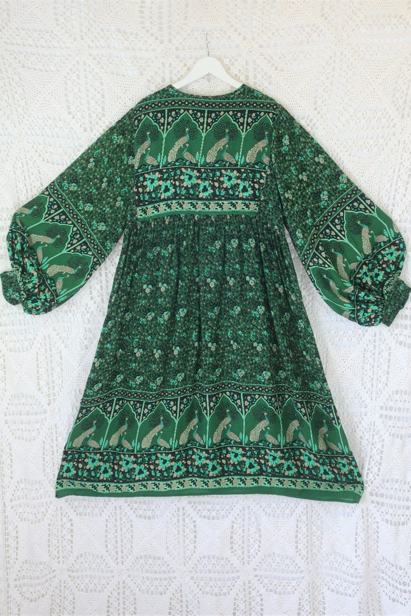 back indian peacock printed primrose midi length dress in forest green with exaggerated balloon sleeve in 1970s vintage inspired bohemian style by all about audrey