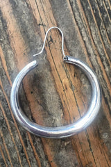 close up to show wire shape on large silver painted hoop earrings from our boho jewellery collection at all about audrey