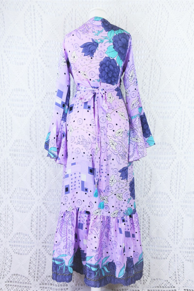 back of dusky purple and aqua floral print sylvia boho wrap dress, with waist ties tied in a bow at the centre of the lower back to cinch the waist
