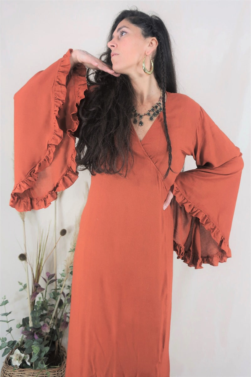 Front close up of model and bell sleeves. Lots of fabric creates an elegant shape with the adjustable cinched in tie wrap waist and accessorised with bohemian chunky jewellery by All About Audrey