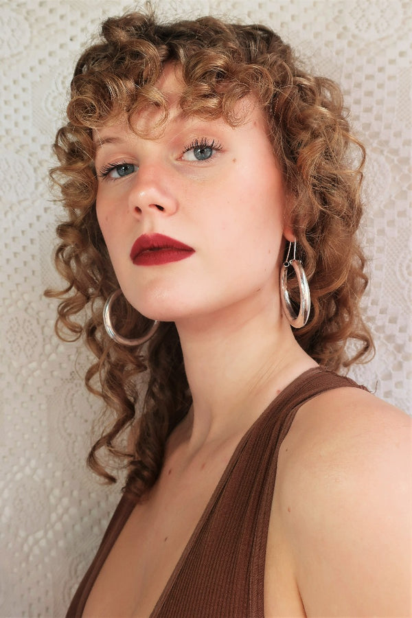 model wears medium silver painted thin hoops from our collection of vintage inspired bohemian jewellery and accessories by all about audrey